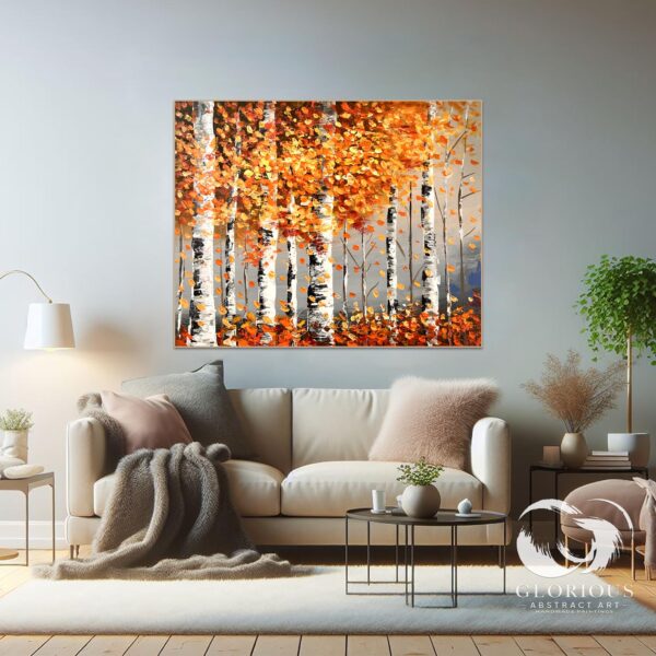 Abstract forest painting with warm fall tones hanging above a sofa