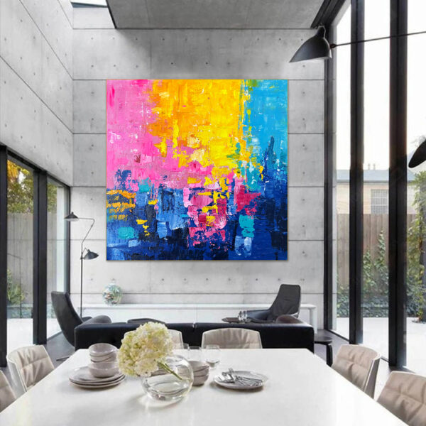 Vibrant abstract painting with pink, yellow, and blue colors on large canvas