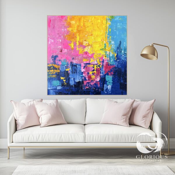 Vibrant abstract painting with bold blue, yellow, and pink brushstrokes on canvas