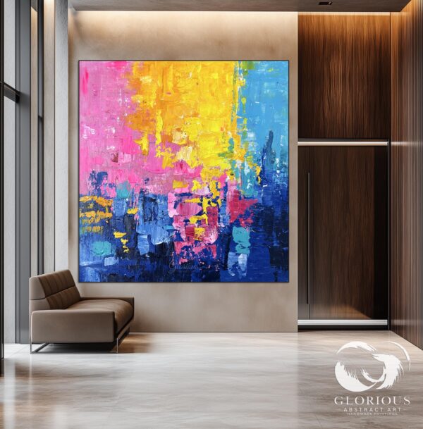 Large abstract canvas art hanging above a sleek modern sofa.