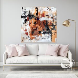 Large orange and black abstract painting with textured brushstrokes hanging on a neutral wall.