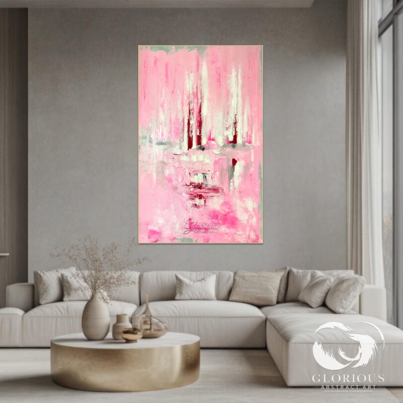 Large pink abstract canvas art displayed above a beige sofa in a cozy, modern room.