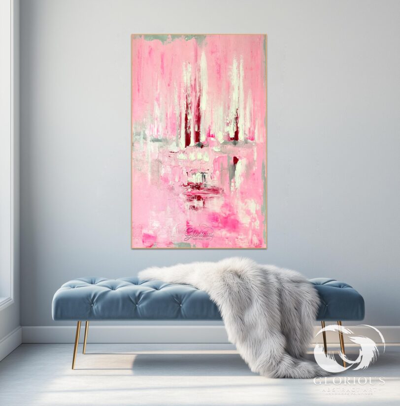 Minimalist abstract painting in pink and white tones styled in a bright living room.