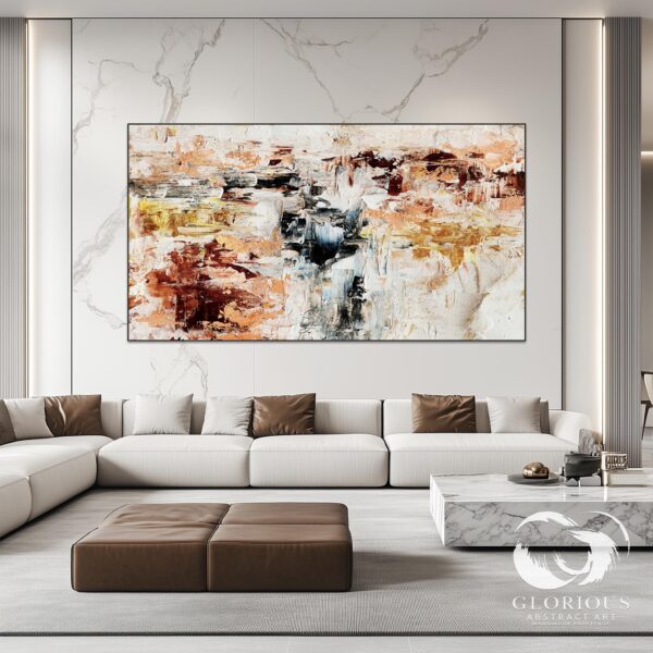 Modern abstract wall art featuring beige, gold, and earthy tones, displayed above a beige sofa.