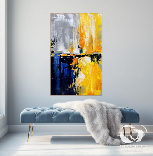 Detailed view of the shimmering gold accents and textured brushwork on a blue and gold abstract painting.