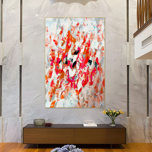 Close-up of abstract painting showcasing bold orange, red, and white strokes