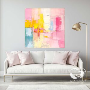 Close-up of vibrant pink and yellow abstract painting with bold textured brushstrokes.