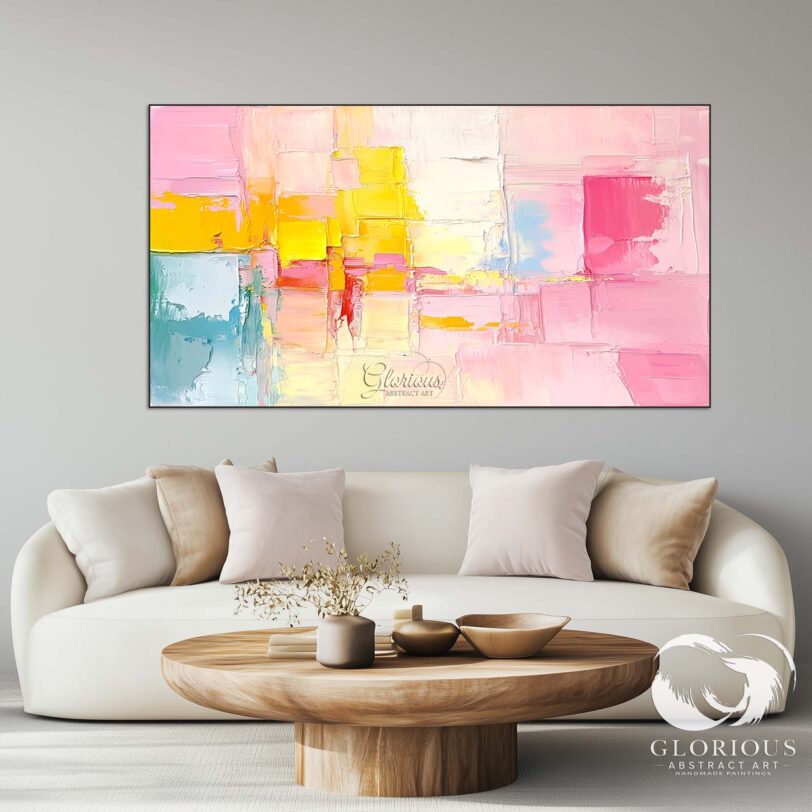 Contemporary abstract canvas art with vibrant colors of pink and yellow, framed and displayed in a gallery setting.