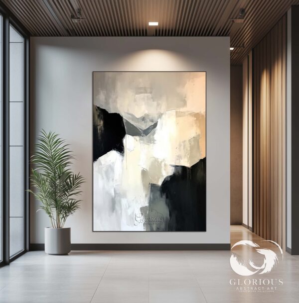 Large abstract painting in black and white, hanging in a modern living room