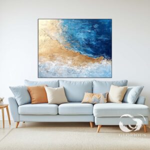 Abstract coastal painting with blue and gold tones in a minimalist room.