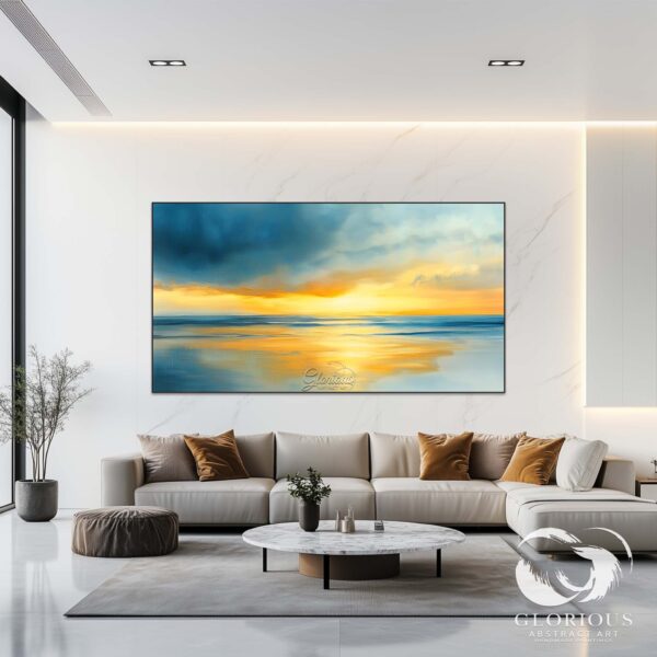 Abstract sunset painting in blue and gold hanging in a modern space