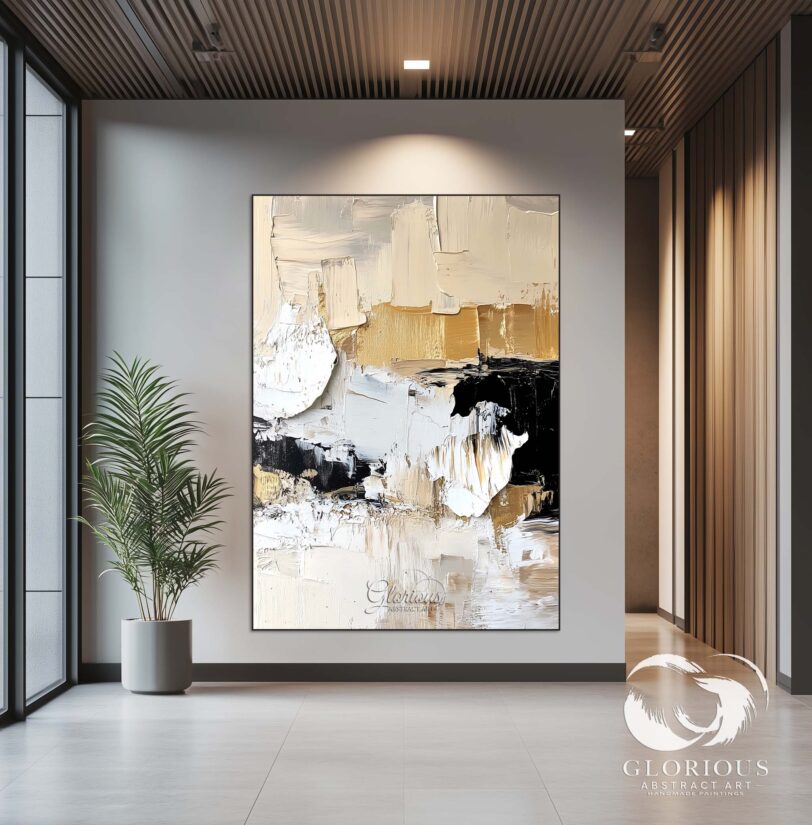 Close-up of layered textures in beige, black, and gold abstract painting.