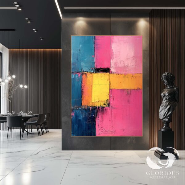 Large modern abstract painting in pink, yellow, and blue hanging in a living room.