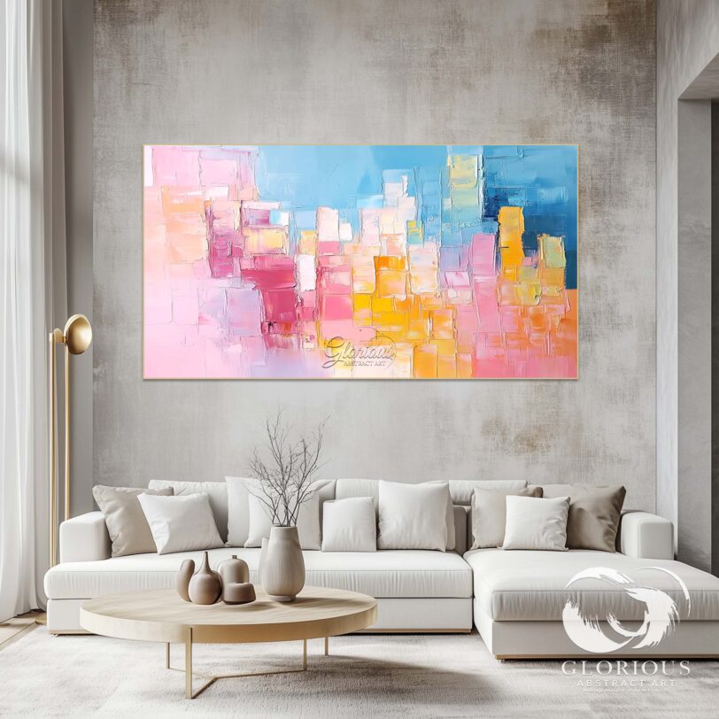 Close-up of textured abstract cityscape painting in blue, pink, and yellow