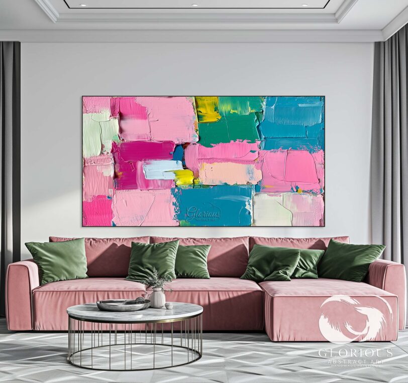 Close-up of a colorful abstract canvas with textured pink, blue, and yellow blocks