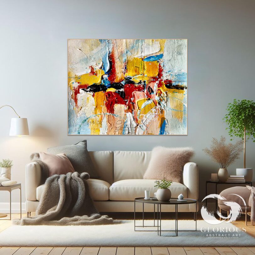 Abstract painting hanging above a white sofa in a contemporary living room