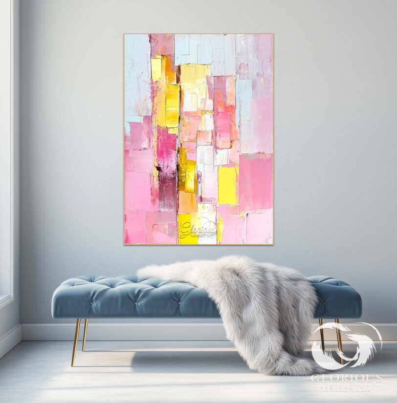 Close-up of textured brushstrokes in pink, yellow, and white on a canvas.