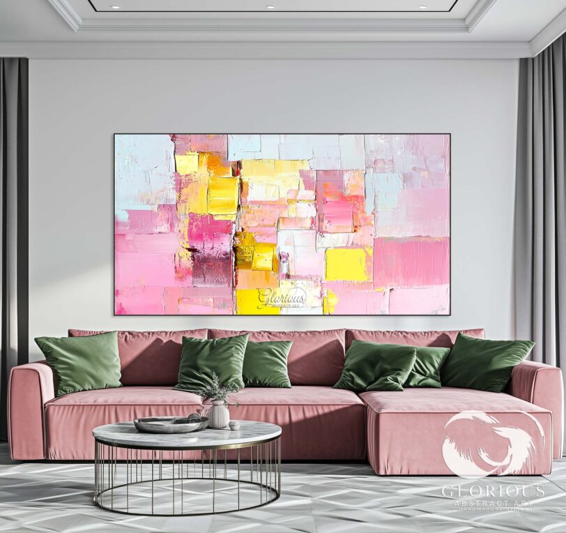 Abstract painting with pink and yellow tones displayed in a home office.