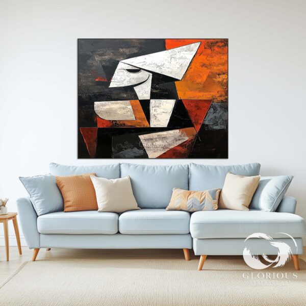 Large geometric abstract painting hanging above a minimalist office desk.