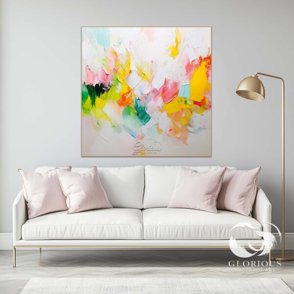 Vibrant abstract painting with bold strokes of yellow, pink, and green displayed in a contemporary living room.