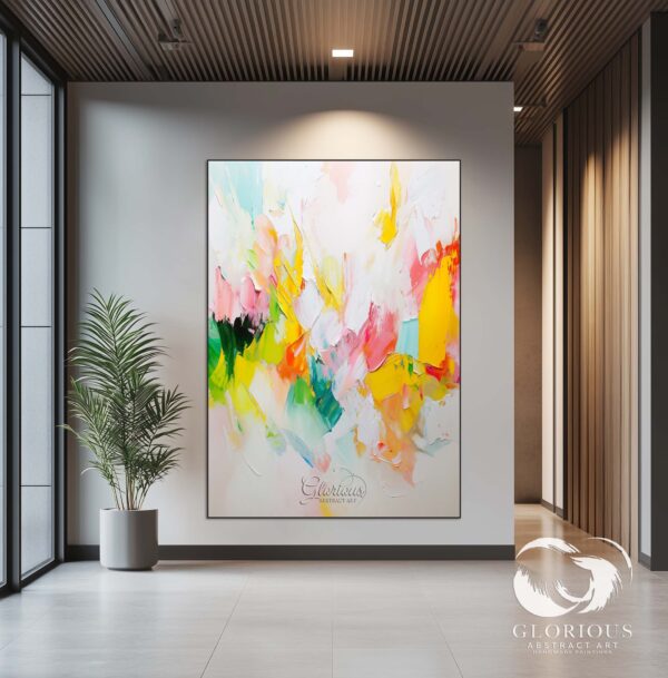 Large abstract painting featuring pink, yellow, and green tones in a minimalist interior.