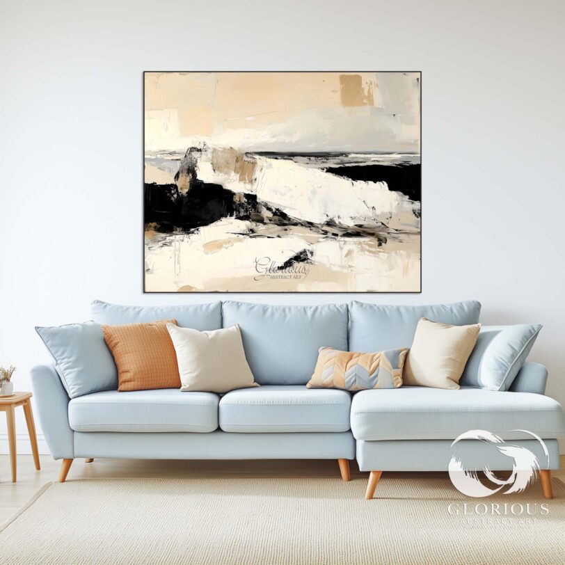 Abstract painting in beige and black tones leaning against a wall with complementary decor items.